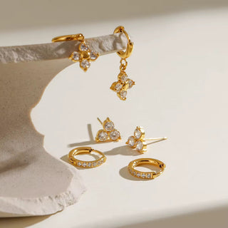 Minimalist hoop and drop earrings in soft white background