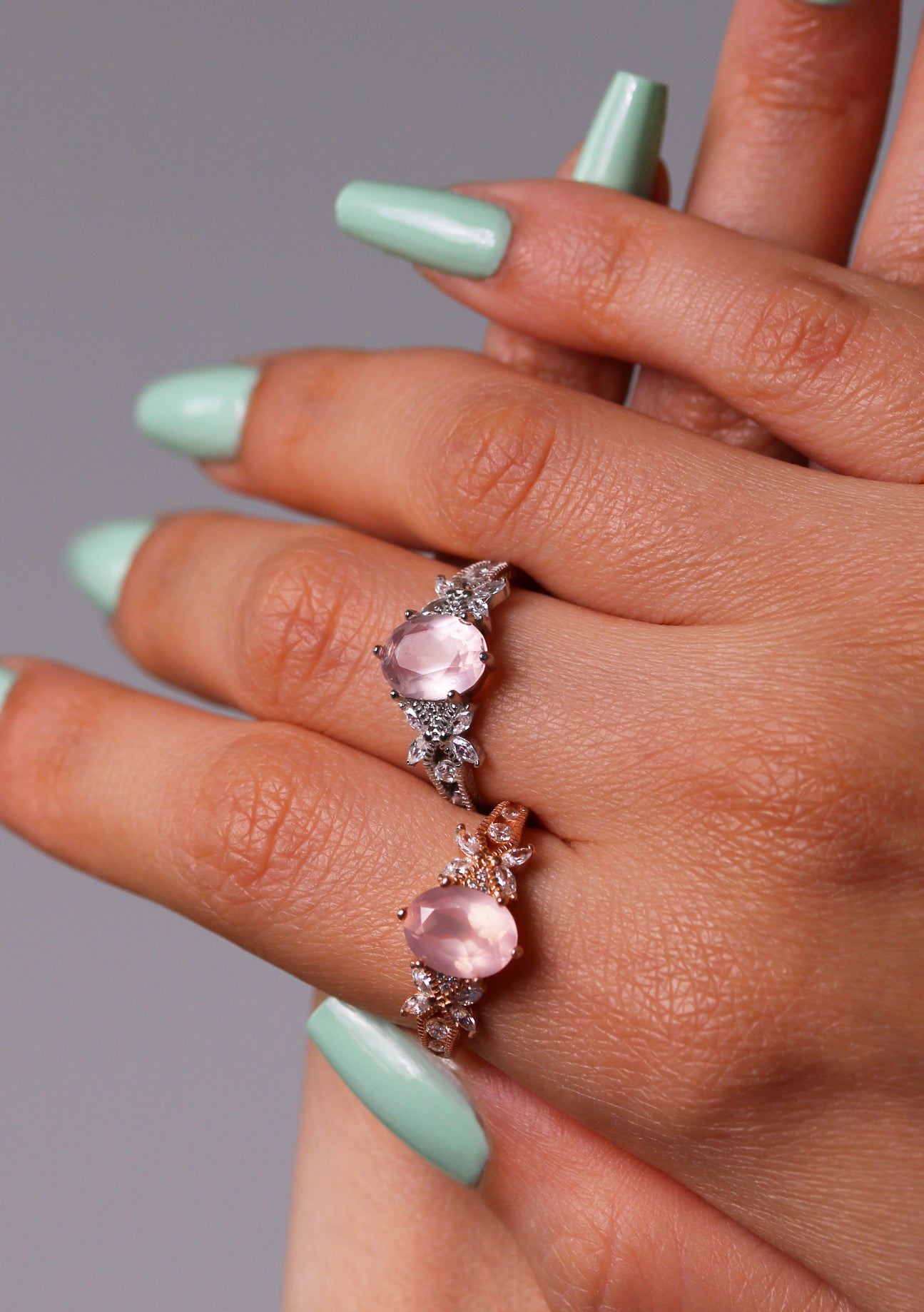 Elegant oval-cut rose quartz ring with silver halo design