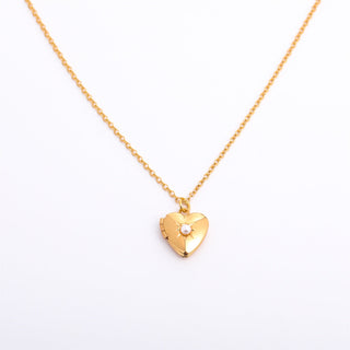 Gold heart-shaped necklace on a white background