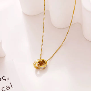 Gold necklace with a pendant on a white background
