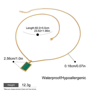 Gold necklace with green pendant and measurement details on a white background