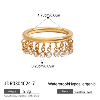 Gold ring with dangling crystals and measurements on a white background