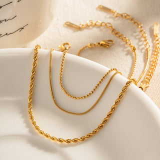 Women’s gold bracelet set with rope, beaded, and box chain designs