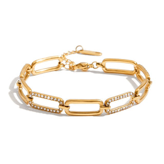 Gold chain bracelet with diamond accents on a white background