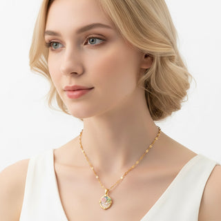 Gold necklace with a heart-shaped pendant featuring a rose and pearl on a white background.