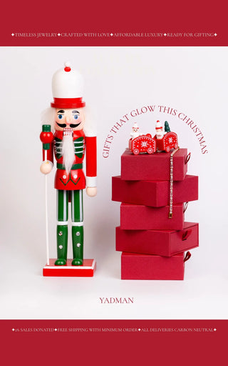 Christmas nutcracker and stacked red gift boxes with Yadman branding.