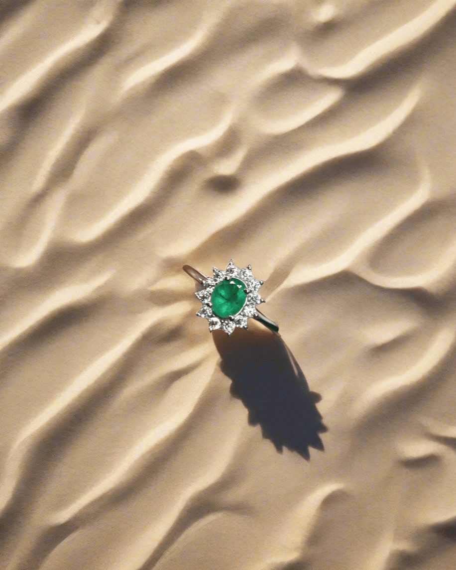 Close-up of platinum-plated ring featuring oval emerald center