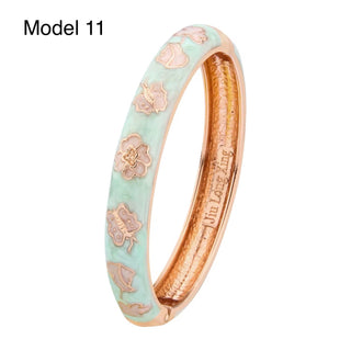 Gold enamel bangle featuring red rose patterns on turquoise background