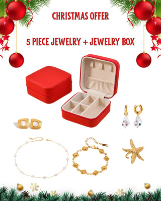 Red jewelry box with gold jewelry and Christmas decorations on a white background