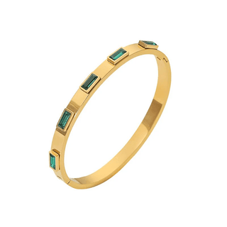 Gold bracelet with green gemstones on a white background