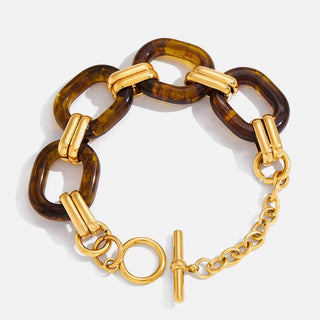 Gold and tortoiseshell chain bracelet on a white background