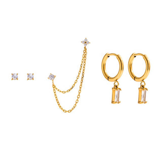 Gold jewelry set with earrings and a necklace on a white background