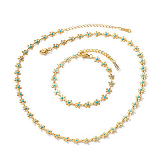 Gold necklace with turquoise stones on a white background