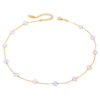 Gold necklace with pearls on a white background
