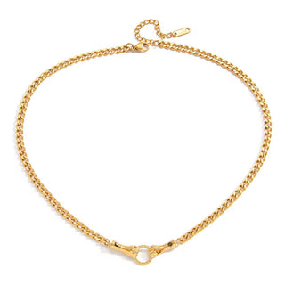 Close-up of sculptural hand pendant on gold chain