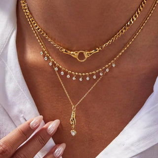 Symbolic gold necklace with clasped hands