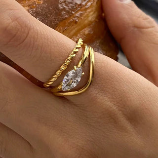 Gold ring with a diamond on a person's finger