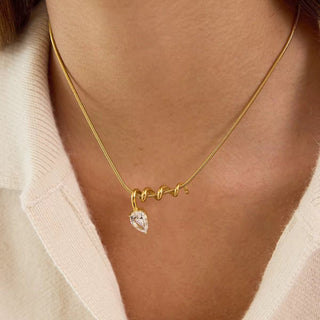 Elegant sculptural gold necklace with white stone