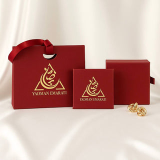 Red boxes with gold logo and 'YADMAN EMARATI' text on a white background