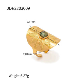 Gold decorative item with measurements and weight on a white background