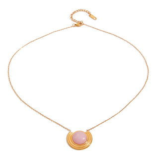 Gold necklace with a pink pendant on a white background