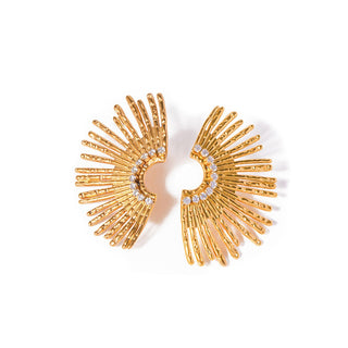 Gold earrings with a sunburst design on a white background