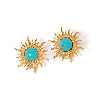 Gold sun-shaped earrings with turquoise centers on a white background