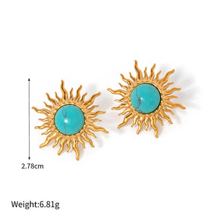 Gold sun-shaped earrings with turquoise centers on a white background