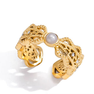 Gold ring with pearl and small diamonds on a white background